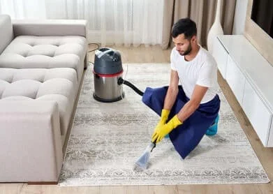 man-cleaning-carpet-living-room-using-vacuum-cleaner-home-min