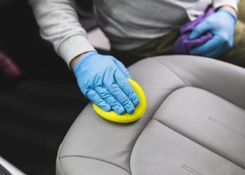 man-cleaning-car-interior-car-detailing-valeting-concept-selective-focus