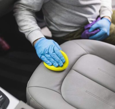 man-cleaning-car-interior-car-detailing-valeting-concept-selective-focus