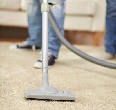 people-housework-housekeeping-concept-close-up-human-legs-vacuum-cleaner-carpet-home