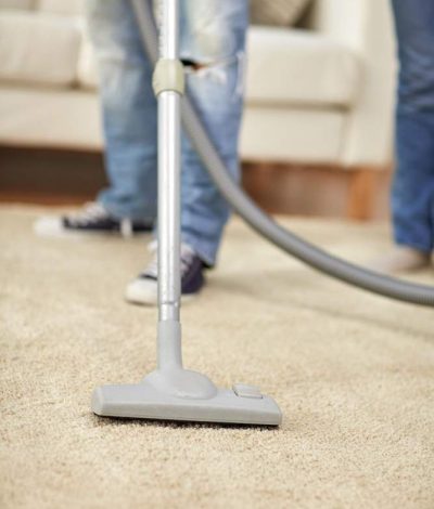 people-housework-housekeeping-concept-close-up-human-legs-vacuum-cleaner-carpet-home