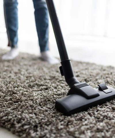 people-housework-housekeeping-concept-close-up-woman-with-legs-vacuum-cleaner-cleaning-carpet-home