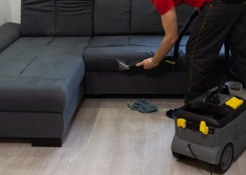 removing-dirt-from-sofa-with-upholstery-cleaner-closeup