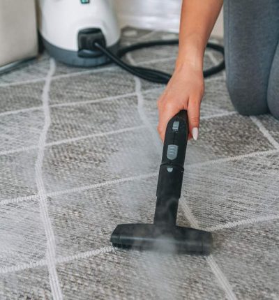 woman-cleaning-carpet-with-steam-cleaner